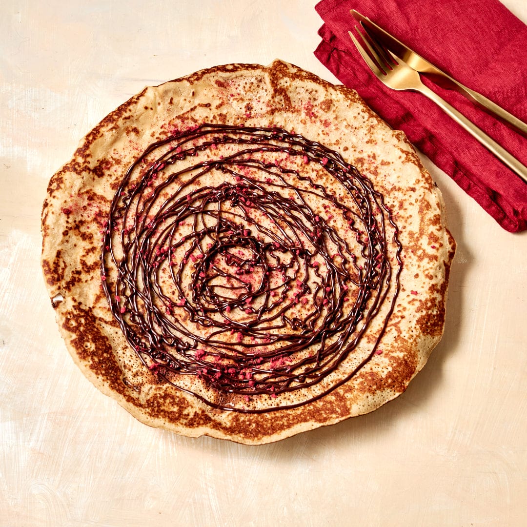 Dessert Sweet Crepe with Chocolate Coulis and Raspberries Crumbs